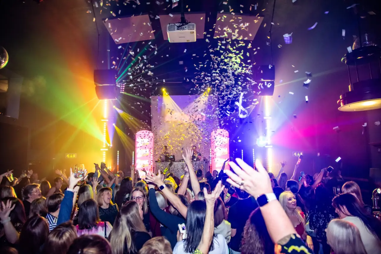 THE 2PM CLUB crowd under confetti and stage lights