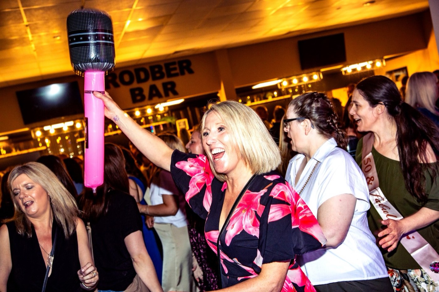 A guest leading the singing with an inflatable microphone